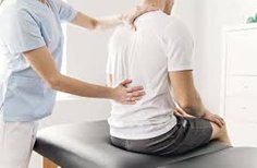 Physical Therapist examining patients lower back.