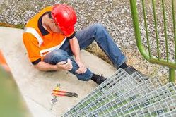 Worker in pain holding shin