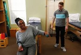 Patient holding waits for strengthening exercises