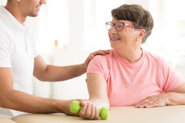 Woman holding a green dumbell