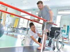 Patient learning to walk with balance bars
