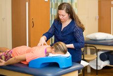 Physical Therapist examining patients back