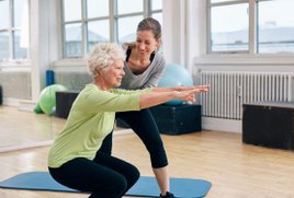 Patient preforming a squat with guidance of a physical therapist