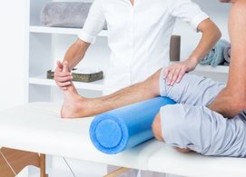 Physical Therapist examining patients knee