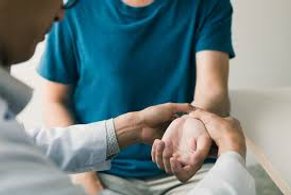 Physical Therapist examining patients wrist