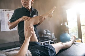 Physical Therapist moving patients knee