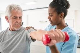 Patient holding dumbbell doing a shoulder exercise