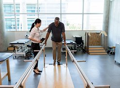 Patient walking on balance bars