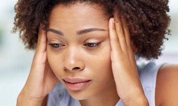 Woman in stress holding her head