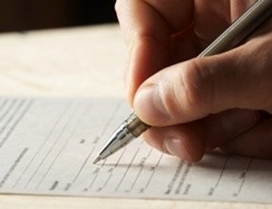 Hand holding pen for writing