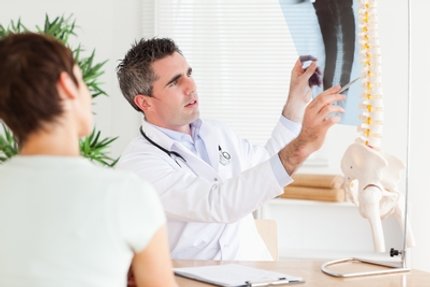 Physical Therapist educating patient about spine